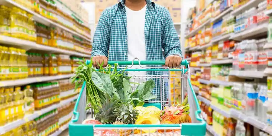 homem usando o benefício do vale-alimentação no supermercado