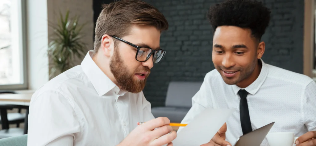 O Gemini disse Esta imagem retrata uma colaboração profissional focada, geralmente associada a mentoria, revisão de projetos ou uma reunião individual (one-on-one).