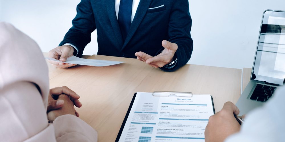 Business situation, job interview concept. Job seeker present resume to managers.