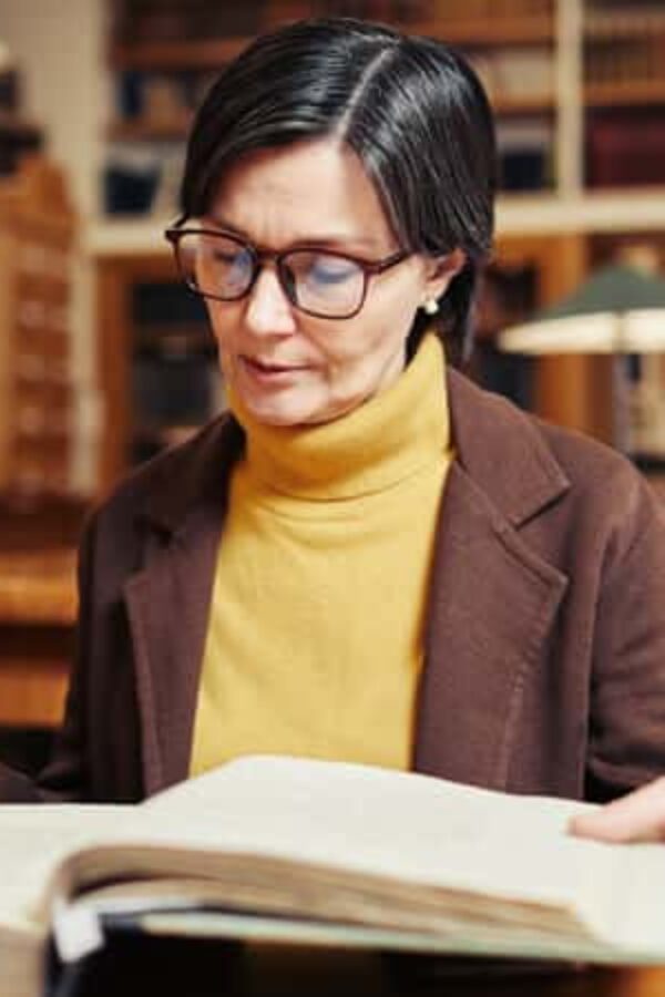 mulher branca sentada em escritório lendo sobre o que é lifelong learning